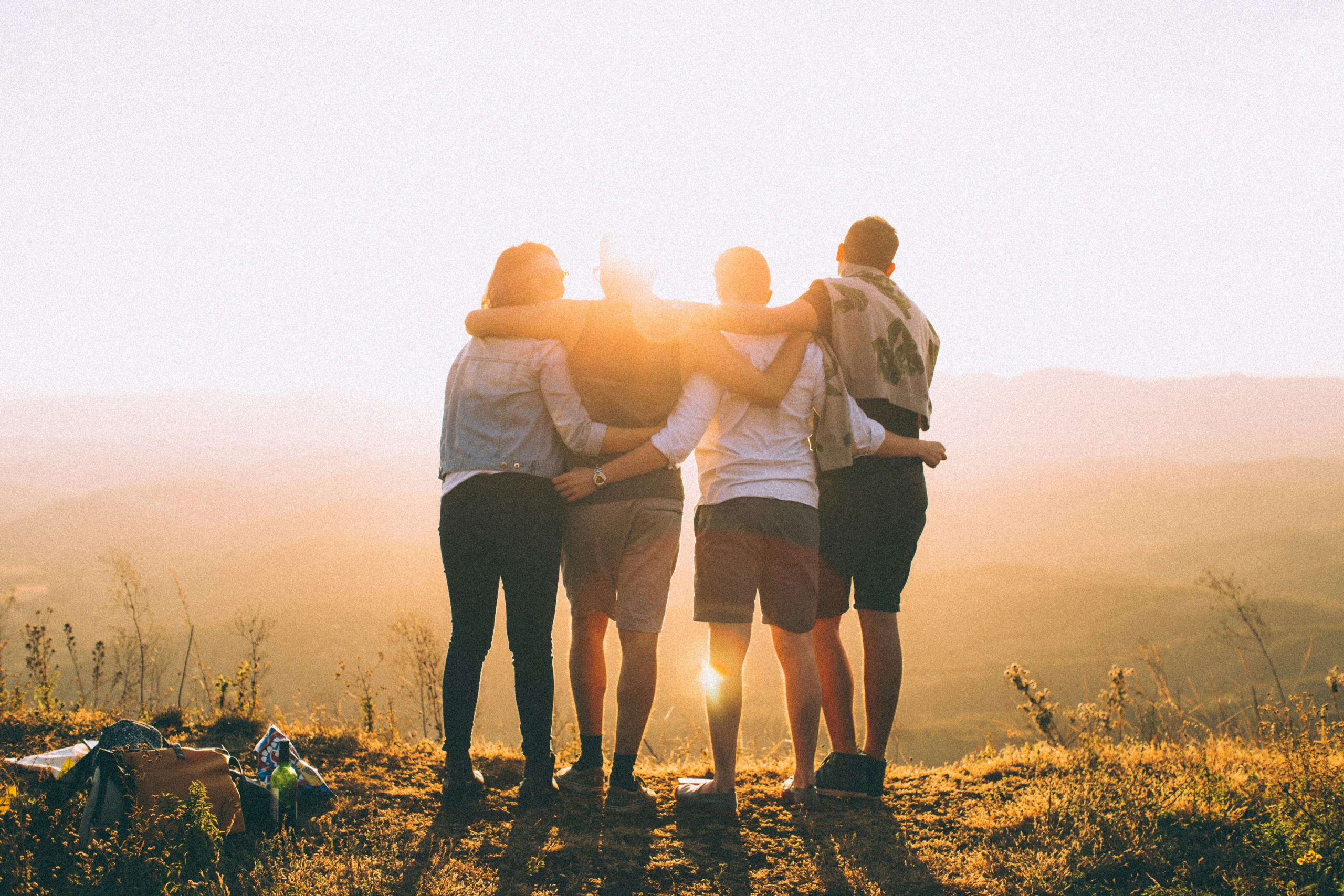 a group of friends enjoying a sunset together