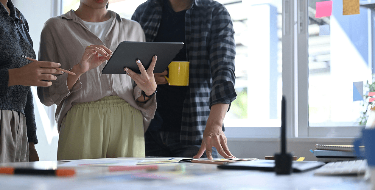 Person holding ipaf performing work while 2 others watch over their shoulder